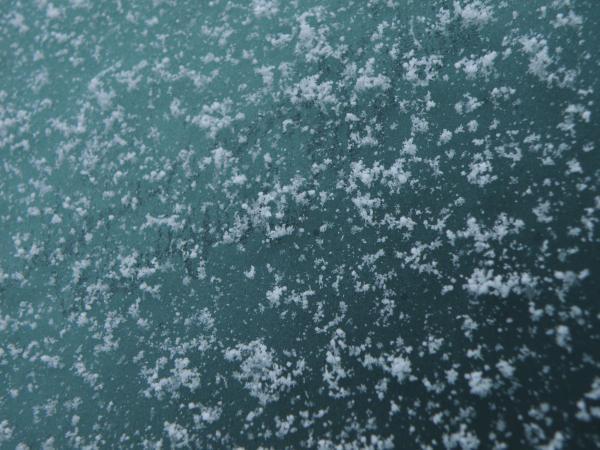 車のフロントガラスに霜と雪
